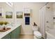 Cozy bathroom with shower and tub, storage cabinet, and a framed landscape art piece at 1536 Liberty Nw Pkwy, Atlanta, GA 30318