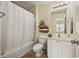 Bright bathroom featuring a shower-tub combo and a single sink vanity with neutral wall colors at 1536 Liberty Nw Pkwy, Atlanta, GA 30318