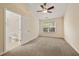 Bedroom with carpet, ceiling fan, neutral walls, window, and an open ensuite bathroom at 1536 Liberty Nw Pkwy, Atlanta, GA 30318