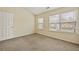 Bright bedroom featuring large windows, carpet flooring, and closet at 1536 Liberty Nw Pkwy, Atlanta, GA 30318