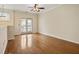 Bright living room featuring hardwood floors, natural light and access to outdoor balcony at 1536 Liberty Nw Pkwy, Atlanta, GA 30318