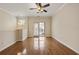 Bright living room featuring hardwood floors, natural light and access to outdoor balcony at 1536 Liberty Nw Pkwy, Atlanta, GA 30318