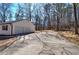 Detached garage with a two-car door, ample driveway parking, and wooded surroundings at 163 Bruce Rd, Douglasville, GA 30134