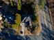 Aerial view of a well-maintained home featuring mature trees and a long driveway at 4129 Lansfaire Ter, Suwanee, GA 30024