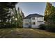 Backyard with mature trees, lush grass, and two story home at 4129 Lansfaire Ter, Suwanee, GA 30024