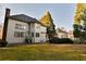 Backyard with patio and two-story home, complete with mature trees at 4129 Lansfaire Ter, Suwanee, GA 30024