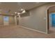 Spacious finished basement with neutral walls, plush carpeting, and multiple entryways at 4129 Lansfaire Ter, Suwanee, GA 30024