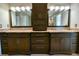 Elegant bathroom vanity featuring double sinks, granite countertops, and dark wood cabinetry at 4129 Lansfaire Ter, Suwanee, GA 30024