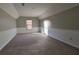 Spacious bonus room with neutral carpet and two-tone paint divided by chair rail at 4129 Lansfaire Ter, Suwanee, GA 30024