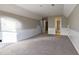 Large bonus room featuring neutral carpeting and light gray walls with white trim and baseboards at 4129 Lansfaire Ter, Suwanee, GA 30024