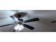 Ceiling fan with light fixture and dark-colored blades at 4129 Lansfaire Ter, Suwanee, GA 30024