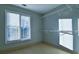 Bright walk-in closet with ample natural light and wire shelving for organized storage at 4129 Lansfaire Ter, Suwanee, GA 30024