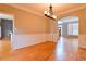 Inviting dining room with hardwood floors, wainscoting, and an elegant chandelier at 4129 Lansfaire Ter, Suwanee, GA 30024