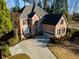 Charming two-story brick home featuring a well-manicured lawn and attached two-car garage at 4129 Lansfaire Ter, Suwanee, GA 30024