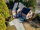 Charming brick home with an attached garage, mature landscaping, and a curved driveway at 4129 Lansfaire Ter, Suwanee, GA 30024