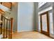 Welcoming foyer with hardwood floors, ornate front door, and staircase at 4129 Lansfaire Ter, Suwanee, GA 30024