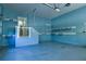 Garage with blue-painted walls, a door leading to the interior, and metal storage racks at 4129 Lansfaire Ter, Suwanee, GA 30024
