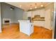 Bright kitchen with white cabinetry, island, granite counters and stainless appliances at 4129 Lansfaire Ter, Suwanee, GA 30024