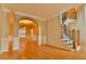 Spacious living room showcasing hardwood floors, staircase, and dining area access at 4129 Lansfaire Ter, Suwanee, GA 30024