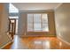 Open-concept living room with hardwood flooring and views of the entryway at 4129 Lansfaire Ter, Suwanee, GA 30024