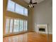 Living room with fireplace, high ceilings, and large windows at 4129 Lansfaire Ter, Suwanee, GA 30024