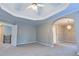 Spacious main bedroom featuring trey ceiling, carpet, and an arched entrance to an adjacent room at 4129 Lansfaire Ter, Suwanee, GA 30024