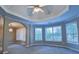 Main bedroom featuring a decorative ceiling, carpet, lots of windows, and an arched entrance at 4129 Lansfaire Ter, Suwanee, GA 30024