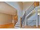 Elegant staircase with hardwood treads and wrought iron balusters in a spacious foyer at 4129 Lansfaire Ter, Suwanee, GA 30024