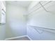 Walk-in closet with wire shelving, neutral gray paint and berber carpet at 4129 Lansfaire Ter, Suwanee, GA 30024