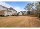 Expansive backyard with a view of neighboring houses, ideal for outdoor activities at 5292 Candleberry Sw Dr, Lilburn, GA 30047
