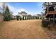 Expansive backyard featuring lawn, bordering shrubs, and a wooden deck structure, ideal for outdoor enjoyment at 5292 Candleberry Sw Dr, Lilburn, GA 30047