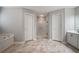 Bathroom showcases a bathtub, large shower, and white cabinets, all on marble-look floors at 5292 Candleberry Sw Dr, Lilburn, GA 30047