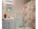 Charming bathroom featuring floral wallpaper, a shower curtain, and a vanity with storage at 5292 Candleberry Sw Dr, Lilburn, GA 30047