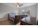 Comfortable bedroom featuring a cozy bed, ceiling fan, and dresser for storage at 5292 Candleberry Sw Dr, Lilburn, GA 30047