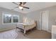 Cozy bedroom with a window view, ceiling fan, and neutral carpet for a peaceful ambiance at 5292 Candleberry Sw Dr, Lilburn, GA 30047