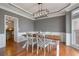 Formal dining room with hardwood floors, modern chandelier, and elegant wainscoting at 5292 Candleberry Sw Dr, Lilburn, GA 30047