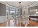Bright dining area with large windows, modern lighting, and beautiful hardwood floors at 5292 Candleberry Sw Dr, Lilburn, GA 30047
