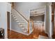 Elegant dining room with hardwood floors, modern chandelier, and view of living area at 5292 Candleberry Sw Dr, Lilburn, GA 30047