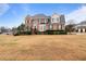 Inviting brick home with lush landscaping and a spacious front yard on a sunny day at 5292 Candleberry Sw Dr, Lilburn, GA 30047