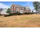 Beautifully landscaped brick home with mature trees and a large front lawn at 5292 Candleberry Sw Dr, Lilburn, GA 30047