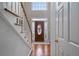 Bright foyer featuring hardwood floors, an elegant staircase, and a decorative front door at 5292 Candleberry Sw Dr, Lilburn, GA 30047