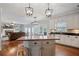 Open-concept kitchen and living area with stainless steel appliances and kitchen island at 5292 Candleberry Sw Dr, Lilburn, GA 30047