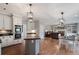 Open-concept kitchen and living area with stainless steel appliances and hardwood floors at 5292 Candleberry Sw Dr, Lilburn, GA 30047