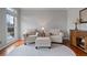 Bright living room featuring two plush armchairs, a patterned rug, and a dark wood accent cabinet at 5292 Candleberry Sw Dr, Lilburn, GA 30047
