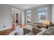 Inviting living room with large windows and hardwood floors at 5292 Candleberry Sw Dr, Lilburn, GA 30047