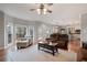 Open concept living room with hardwood floors and view into the kitchen and backyard at 5292 Candleberry Sw Dr, Lilburn, GA 30047