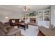 Spacious living room with a cozy fireplace, custom shelving, and ample seating at 5292 Candleberry Sw Dr, Lilburn, GA 30047
