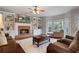 Cozy living room featuring built-in bookshelves, a fireplace, and comfortable seating at 5292 Candleberry Sw Dr, Lilburn, GA 30047