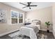 Bright bedroom featuring hardwood floors, ceiling fan, and large window at 5403 Woodberry Cir, Marietta, GA 30068