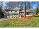Charming split-level home featuring a garage, a welcoming front yard, and a light-blue painted front door at 5403 Woodberry Cir, Marietta, GA 30068
